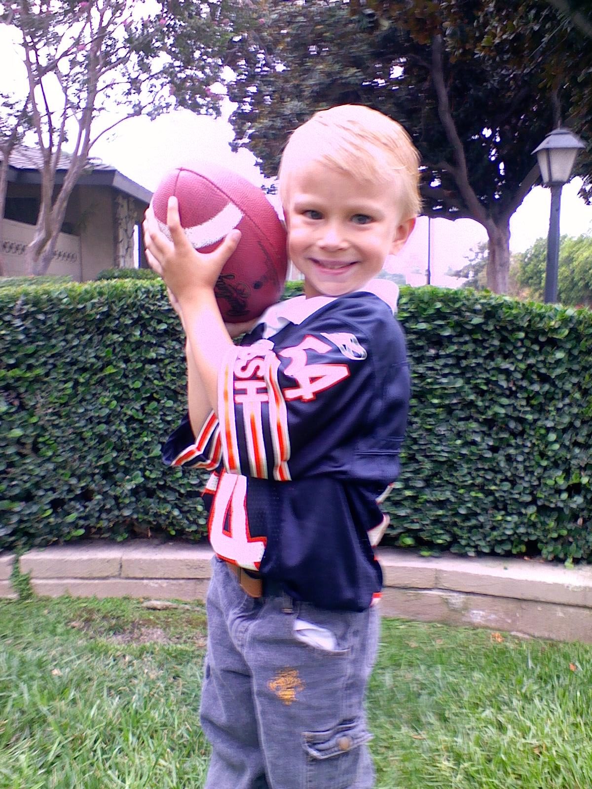 Nathaniel holding a football 